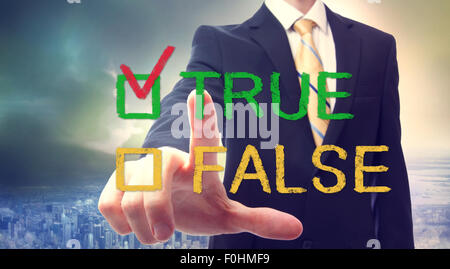 Businessman pointing at TRUE or FALSE checkbox Stock Photo