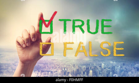 Hand pointing at TRUE or FALSE checkbox Stock Photo