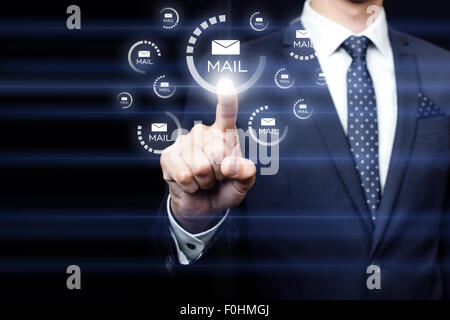 Businessman clicking on email icon Stock Photo