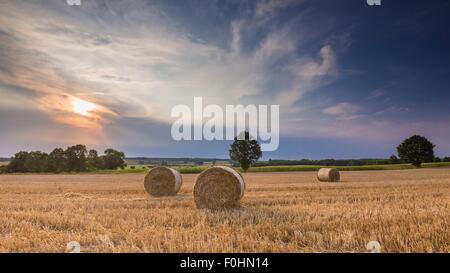 Stubble field with straw bales. Beautiful summertime rural landscape photographed in Poland. Stock Photo