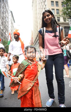 New York City, United States. 16th Aug, 2015. Little girl in traditional attire marches with mom and Indian flag. The Federation of India staged its 35th annual India Day Parade along Madison Avenue in Midtown, New York. © Andy Katz/Pacific Press/Alamy Live News Stock Photo