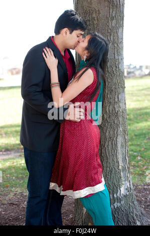 A young and happy Indian couple kissing each other on a sunny day Stock ...