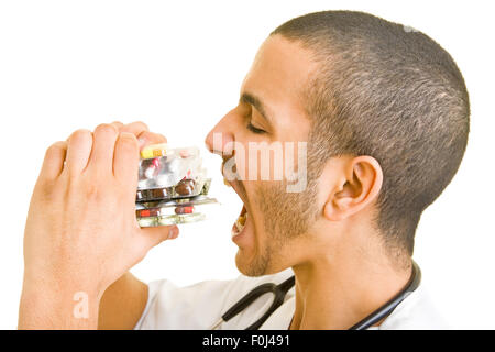 Funny doctor eating a stack of pills Stock Photo