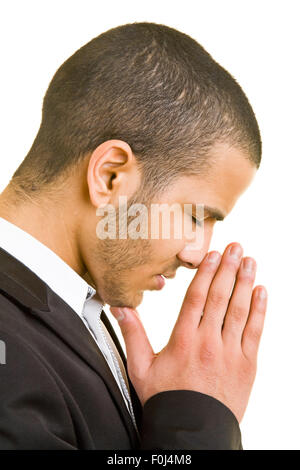Young business man praying with his hands folded Stock Photo
