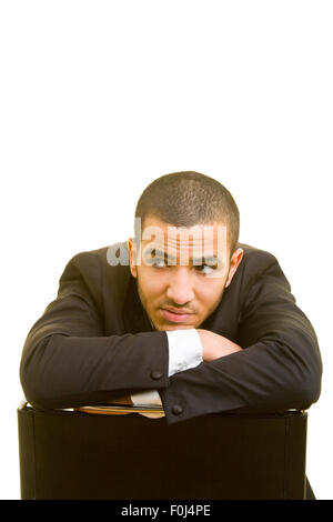 Pensive manager on a chair looking up Stock Photo
