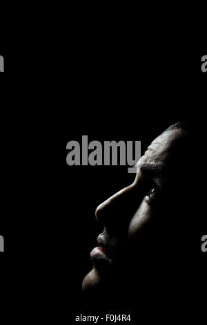Young man at night looking up pensively Stock Photo