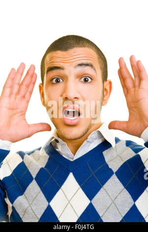 Young man looking afraid and shocked into the camera Stock Photo