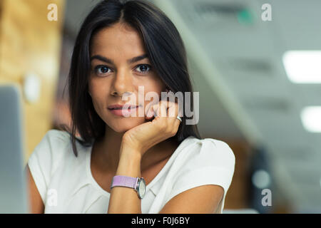 Portrait of a young beautiful businesswoman in office looking at camera Stock Photo
