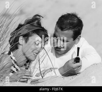 people, couples, lovers, young couple lying on the beach and talking to each other, 1960s, Additional-Rights-Clearences-Not Available Stock Photo