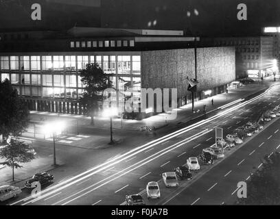 geography / travel,Germany,Berlin,building,Deutsche Oper,built 1957 - 1961,architect: Fritz Bornemann,exterior view,night shot,1963,German Opera,opera house,opera houses,night,dark,darkness,architecture,lights,Volkswagen,VW beetle,parking,parking spot,parking spaces,parking spots,parkings,in a parking space,find a place park,street,streets,Charlottenburg,street lighting,street lamps,street lamp,band of light,light strip,light strips,light line,light lines,transport,transportation,people,Central Europe,Europe,West Berli,Additional-Rights-Clearences-Not Available Stock Photo