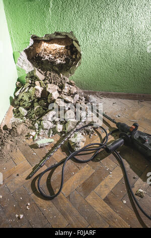 Drilling a big hole in the wall. Drill Stock Photo