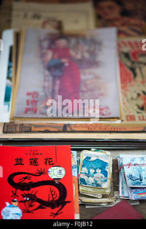 Book Tin-tin in chinese and other old and vintage products on a flea market in Shanghai, 2013. Stock Photo