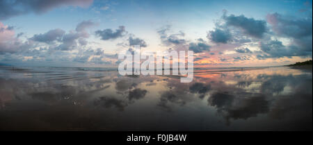 Sunset view at the beach of Matapalo with silhouette of people having a walk, Costa Rica. Stock Photo