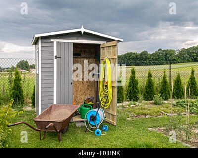 Wooden shed with different garden tools and equipment Stock Photo