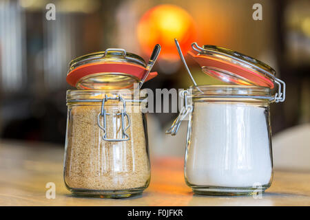 brown and white sugar in glass cups, in a café Stock Photo