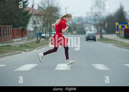 children crossing street on crosswalk Stock Photo