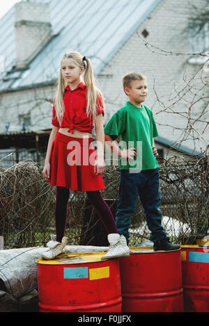 children play at dump drums Stock Photo