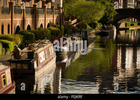 Barges moored along Birmingham's Old Line Canal in evening summer sunlight Stock Photo
