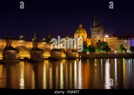 View at night across the Vltava River in Prague with Charles Bridge St Francis Church