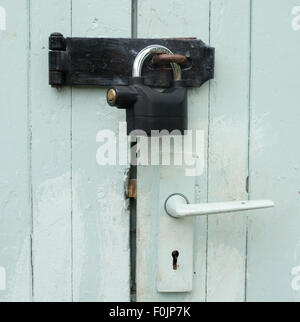 An alarmed padlock on an shed garage door Stock Photo