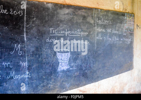 Black board in a rural African school showing a drum under the title 'ICT - Informatics' and asking students to draw the drum. Stock Photo
