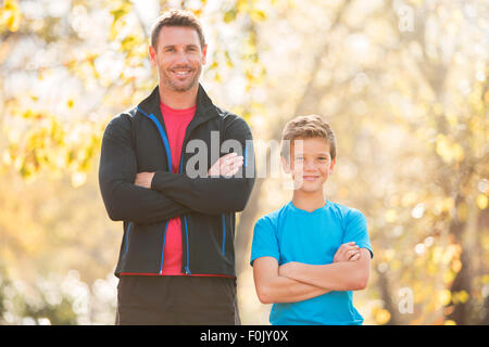 Portrait confident father and son with arms crossed outdoors Stock Photo