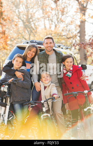 Portrait smiling family with mountain bikes outdoors Stock Photo