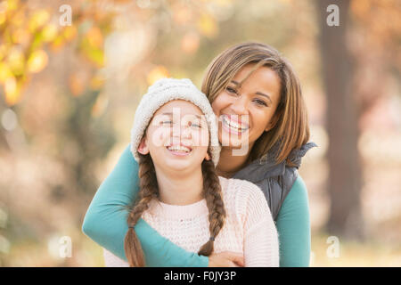 Portrait enthusiastic mother and daughter hugging outdoors Stock Photo