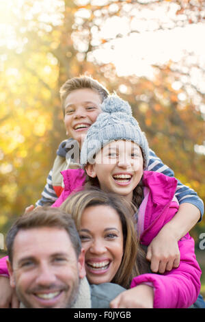 Portrait enthusiastic family hugging outdoors Stock Photo