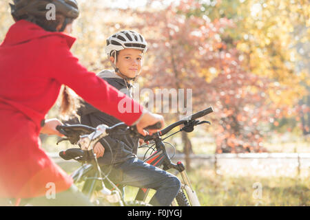 Portrait boy bike riding in autumn park Stock Photo