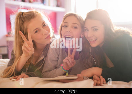 Portrait teenage girls gesturing peace sign Stock Photo