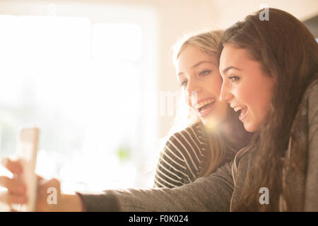 Candid portrait of two girls with arms around each other in garden ...