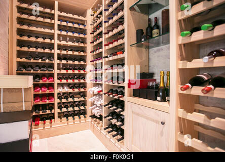 Wine bottles organized on racks in wine cellar Stock Photo