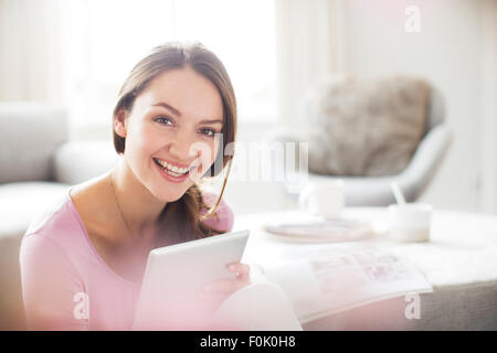 Portrait of enthusiastic woman with digital tablet Stock Photo