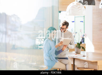 Couple using digital tablet in kitchen Stock Photo