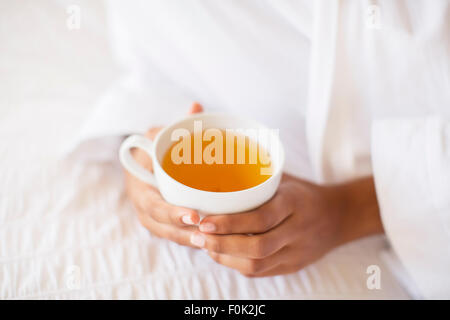 Close up woman holding cup of tea Stock Photo