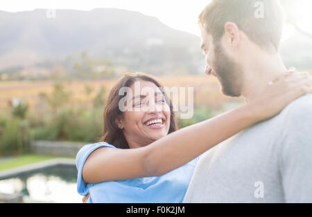 Enthusiastic couple hugging outdoors Stock Photo