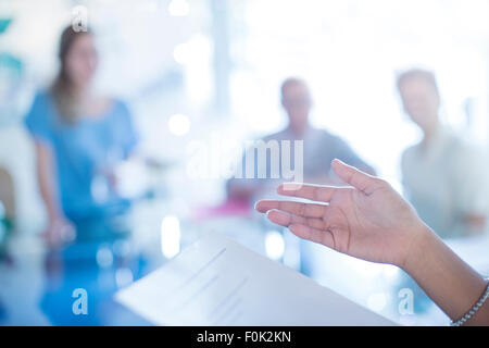Close up of businesswoman’s hand gesturing to paperwork in meeting Stock Photo