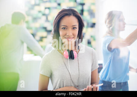 Portrait confident creative businesswoman with headphones in office Stock Photo