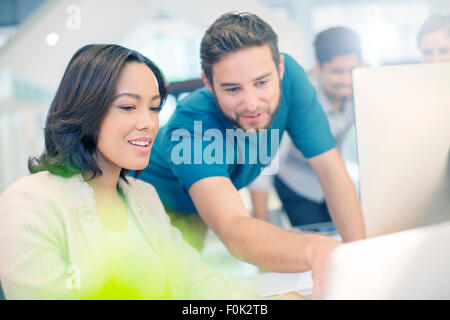 Creative business people using laptop in office Stock Photo