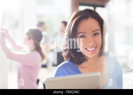 Portrait confident businesswoman with digital tablet Stock Photo