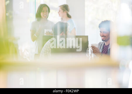 Creative business people drinking coffee and talking office Stock Photo