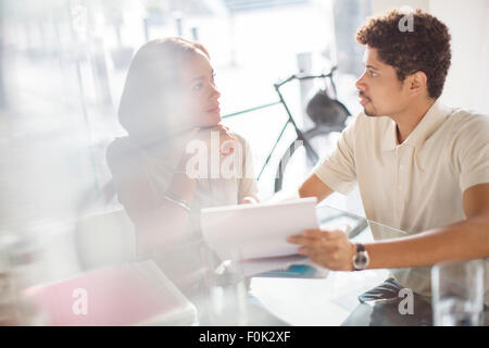 Creative business people reviewing paperwork in office Stock Photo