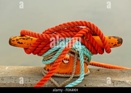 Mooring bollard with rope on pier by the sea. Stock Photo