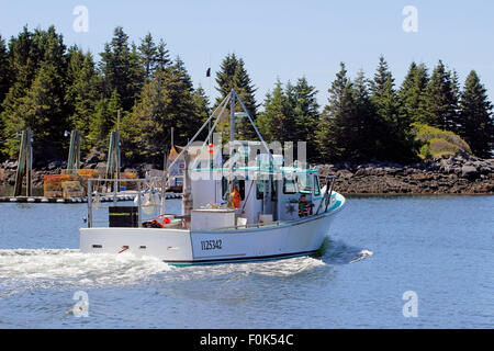 Lobster boats on moorings in harbor waterfront Vinalhaven Island Maine New England USA Stock Photo