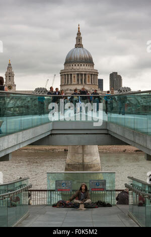 A homeless man and dog begging on the Millennium Bridge,near St Pauls Cathedral; London, England GB Stock Photo