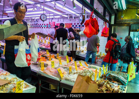 New York City, USA, Chinatown, Fish Store Chinese Man Carrying Shopping Bags,  'Win Sea Food Market', Canal Street, local consumption, multi ethnic store street Stock Photo