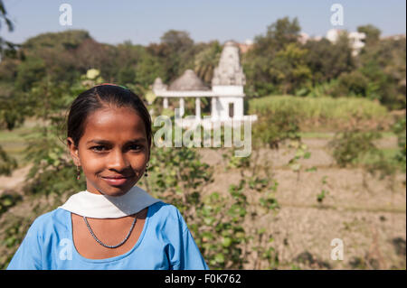 India; road from Udaipur to Jodhpur. Girl in school uniform by a temple. Stock Photo