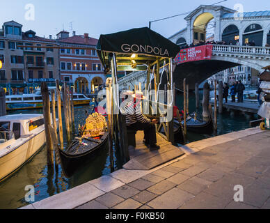 VENICE, ITALY - 14TH MARCH 2015: Men and Gondolas along the Grand Canal Stock Photo