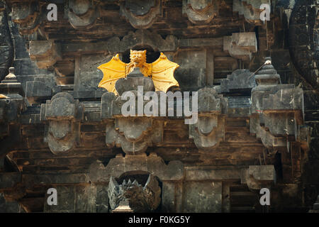 Intricately carved facade of Goa Lawah Bat Cave Temple, including dramatic, stylized sculptures of bats, in Bali, Indonesia. Stock Photo